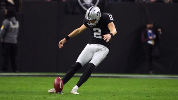 Raiders kicker Daniel Carlson kicks off.